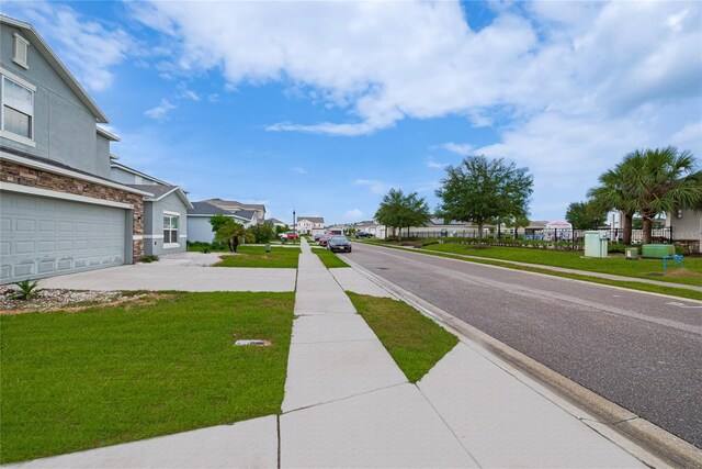 454 Hamlet Loop, Davenport, FL 33837 - view of asphalt road featuring sidewalks, a residential view, and curbs
