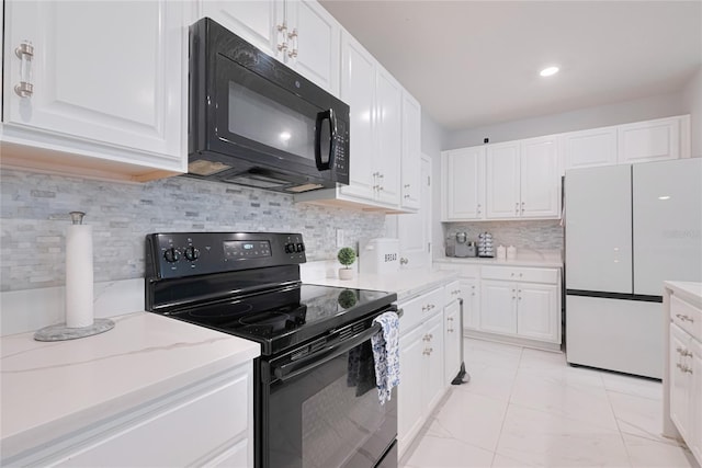 454 Hamlet Loop, Davenport, FL 33837 - kitchen with black appliances, white cabinetry, light marble finish floors, backsplash, and recessed lighting