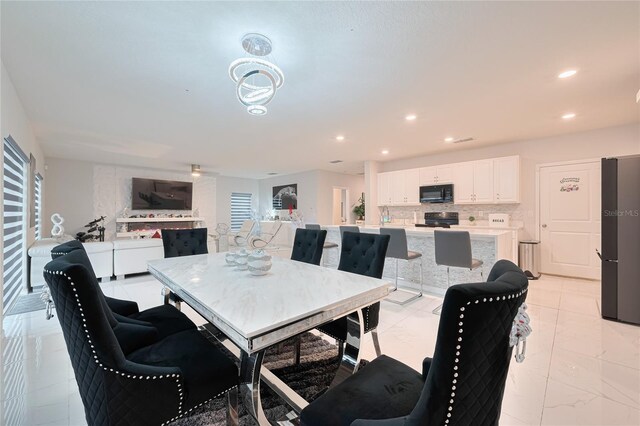 454 Hamlet Loop, Davenport, FL 33837 - dining room with light marble finish flooring and recessed lighting