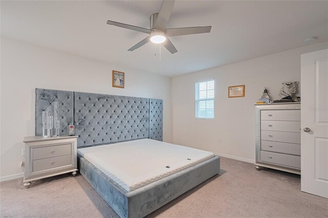 454 Hamlet Loop, Davenport, FL 33837 - bedroom featuring light carpet, baseboards, and ceiling fan