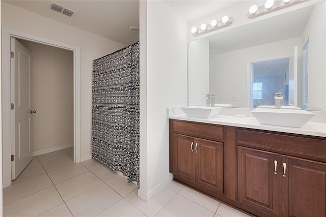 454 Hamlet Loop, Davenport, FL 33837 - full bathroom with double vanity, tile patterned flooring, and baseboards