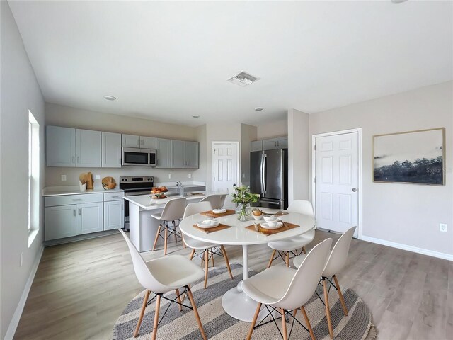 1404 Axel Cir, Winter Haven, FL 33880 - dining area with baseboards and light wood-style floors