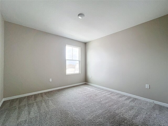 1404 Axel Cir, Winter Haven, FL 33880 - spare room featuring carpet floors and baseboards
