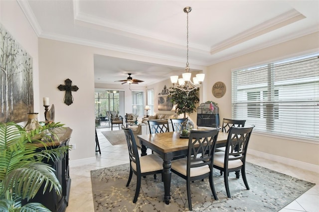 1703 Encinitas Way, Kissimmee, FL 34759 - dining room with a tray ceiling, light tile patterned floors, crown molding, a chandelier, and baseboards
