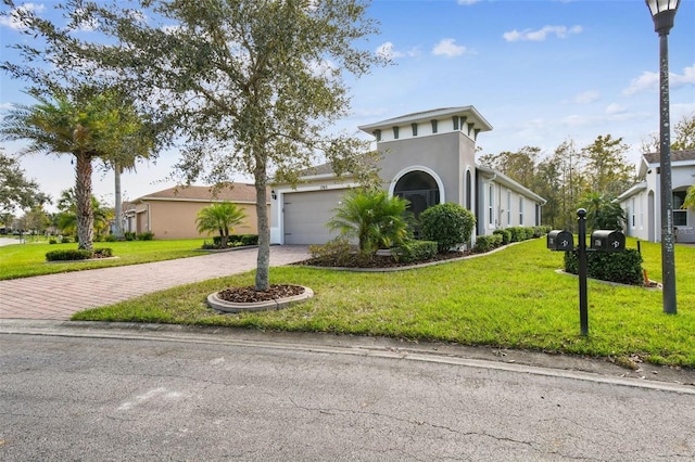 1703 Encinitas Way, Kissimmee, FL 34759 - mediterranean / spanish-style house featuring decorative driveway, a garage, stucco siding, and a front lawn