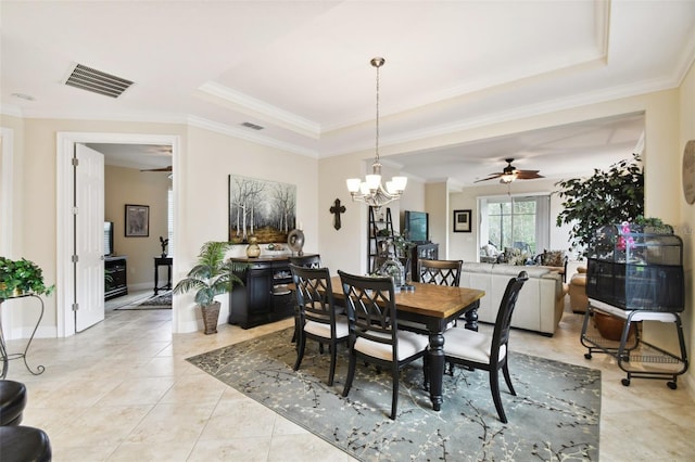 1703 Encinitas Way, Kissimmee, FL 34759 - dining space with a ceiling fan, a tray ceiling, a chandelier, crown molding, and light tile patterned floors