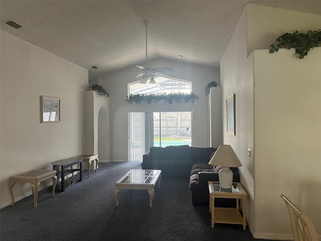 123 S Roma Way, Kissimmee, FL 34746 - carpeted living area featuring vaulted ceiling, ceiling fan, a textured ceiling, arched walkways, and baseboards