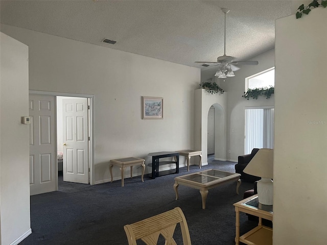 123 S Roma Way, Kissimmee, FL 34746 - carpeted living area featuring arched walkways, a ceiling fan, a textured ceiling, and baseboards