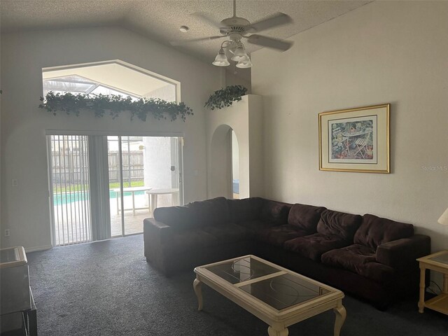123 S Roma Way, Kissimmee, FL 34746 - carpeted living area featuring a ceiling fan, a textured ceiling, arched walkways, and high vaulted ceiling