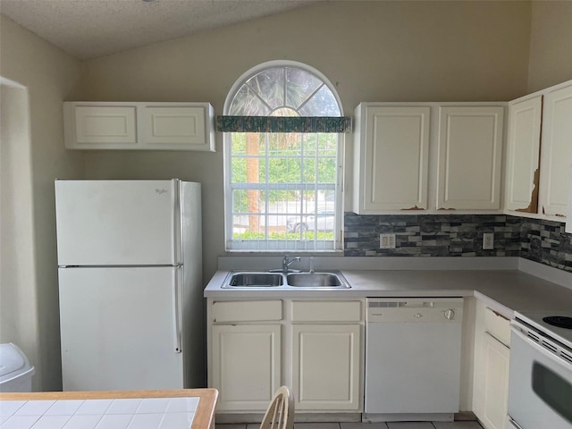 123 S Roma Way, Kissimmee, FL 34746 - kitchen with white appliances, a sink, white cabinetry, backsplash, and light countertops