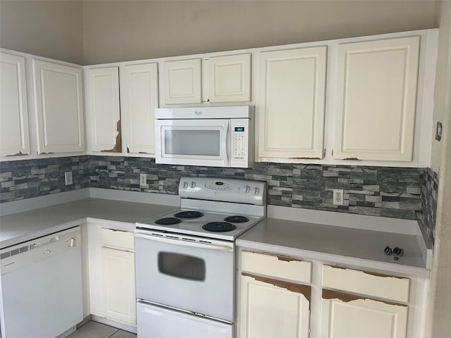 123 S Roma Way, Kissimmee, FL 34746 - kitchen with white appliances, decorative backsplash, light countertops, and white cabinets
