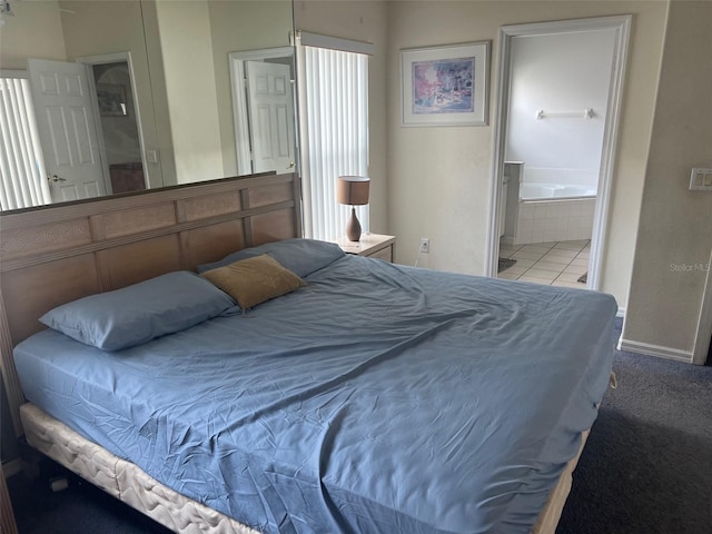 123 S Roma Way, Kissimmee, FL 34746 - carpeted bedroom with connected bathroom and baseboards