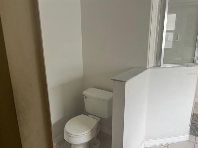 123 S Roma Way, Kissimmee, FL 34746 - bathroom featuring toilet, baseboards, and tile patterned floors