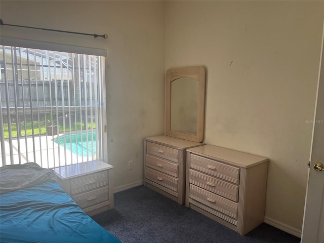 123 S Roma Way, Kissimmee, FL 34746 - bedroom with dark colored carpet, baseboards, and access to outside