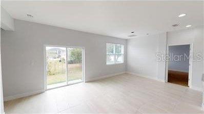 212 Grouper Ct, Poinciana, FL 34759 - spare room with baseboards and recessed lighting