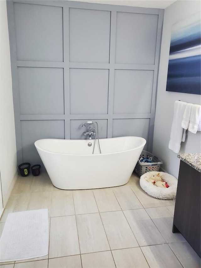 212 Grouper Ct, Poinciana, FL 34759 - bathroom featuring a freestanding tub and tile patterned floors