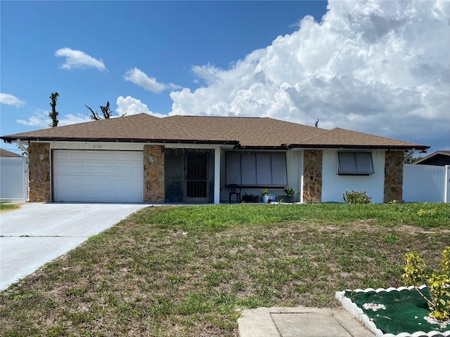 12322 Alta Mira St, North Port, FL 34287 - ranch-style home with stone siding, an attached garage, driveway, and roof with shingles