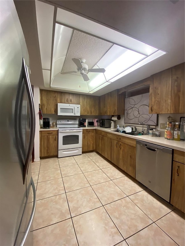 12322 Alta Mira St, North Port, FL 34287 - kitchen featuring stainless steel appliances, a sink, light countertops, and brown cabinets