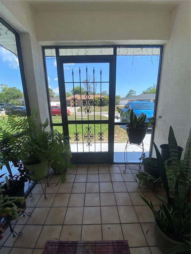 12322 Alta Mira St, North Port, FL 34287 - doorway with light tile patterned flooring and a textured wall