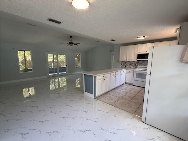 6489 Creation St, Saint Cloud, FL 34771 - kitchen with white appliances, a peninsula, open floor plan, white cabinetry, and decorative backsplash