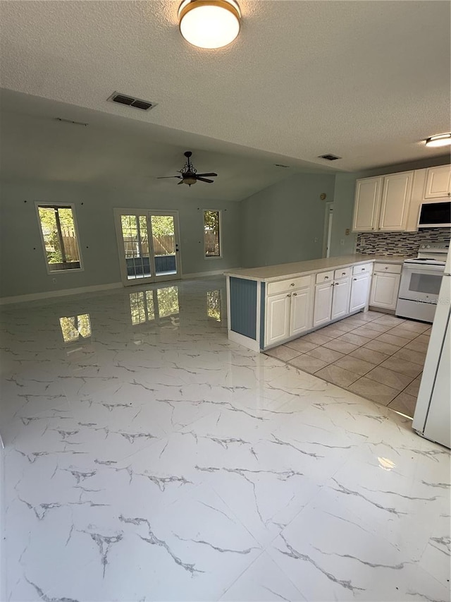 6489 Creation St, Saint Cloud, FL 34771 - kitchen featuring white appliances, a textured ceiling, tasteful backsplash, a ceiling fan, and a peninsula