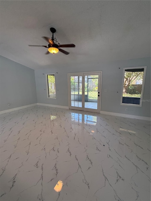 6489 Creation St, Saint Cloud, FL 34771 - spare room with baseboards, a ceiling fan, a textured ceiling, and marble finish floors