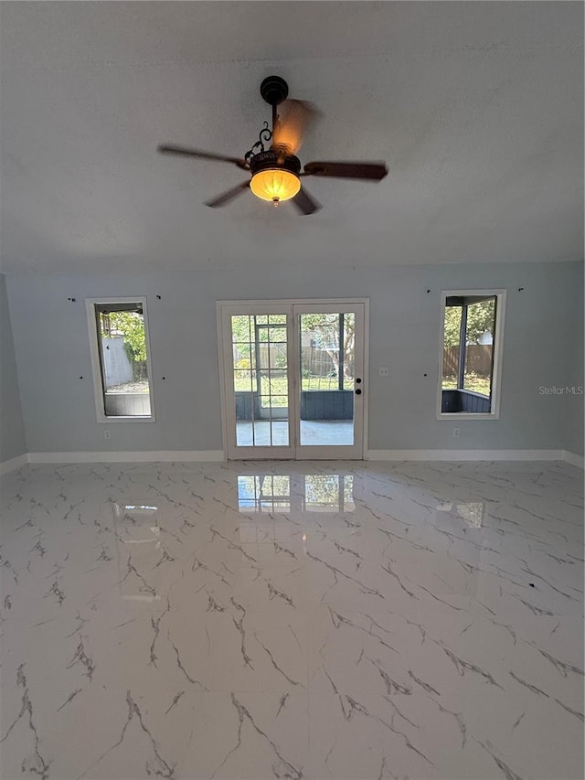 6489 Creation St, Saint Cloud, FL 34771 - spare room featuring a ceiling fan, baseboards, a textured ceiling, and marble finish flooring