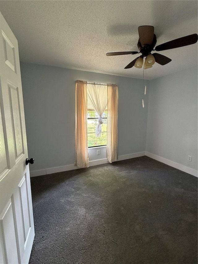 6489 Creation St, Saint Cloud, FL 34771 - spare room with dark carpet, a ceiling fan, baseboards, and a textured ceiling