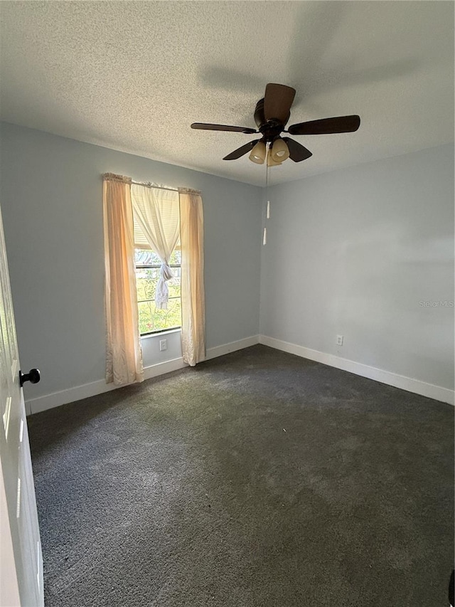 6489 Creation St, Saint Cloud, FL 34771 - empty room with a ceiling fan, dark colored carpet, baseboards, and a textured ceiling