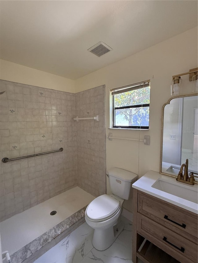 6489 Creation St, Saint Cloud, FL 34771 - bathroom featuring vanity, toilet, marble finish floors, and a tile shower