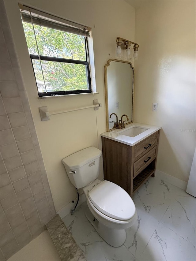 6489 Creation St, Saint Cloud, FL 34771 - bathroom featuring marble look tiles, toilet, and vanity