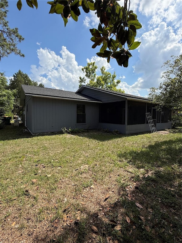 6489 Creation St, Saint Cloud, FL 34771 - rear view of property with a sunroom and a yard