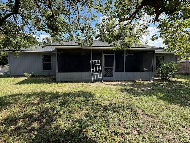6489 Creation St, Saint Cloud, FL 34771 - back of property with a sunroom, ceiling fan, and a shingled roof