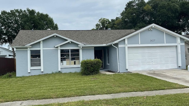 1427 Orchid Ln, Kissimmee, FL 34744 - single story home featuring a garage, a shingled roof, concrete driveway, and a front yard