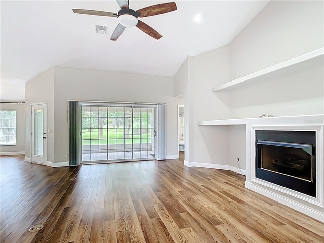 30 Lake Diamond Ave, Ocala, FL 34472 - unfurnished living room with a fireplace, high vaulted ceiling, wood finished floors, baseboards, and ceiling fan