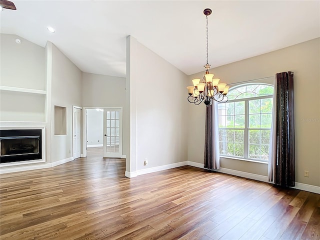 30 Lake Diamond Ave, Ocala, FL 34472 - unfurnished living room featuring wood finished floors, vaulted ceiling, a chandelier, baseboards, and recessed lighting