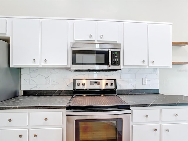 30 Lake Diamond Ave, Ocala, FL 34472 - kitchen with appliances with stainless steel finishes, dark countertops, open shelves, and white cabinets