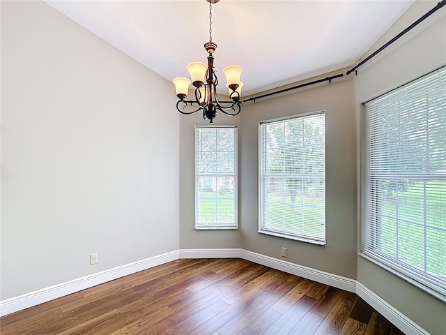 30 Lake Diamond Ave, Ocala, FL 34472 - unfurnished room featuring a chandelier, dark wood-style floors, plenty of natural light, and baseboards