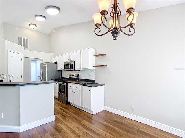 30 Lake Diamond Ave, Ocala, FL 34472 - kitchen featuring stainless steel appliances, dark countertops, baseboards, a chandelier, and white cabinetry
