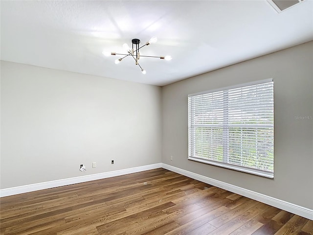 30 Lake Diamond Ave, Ocala, FL 34472 - unfurnished room with a chandelier, baseboards, and dark wood-type flooring