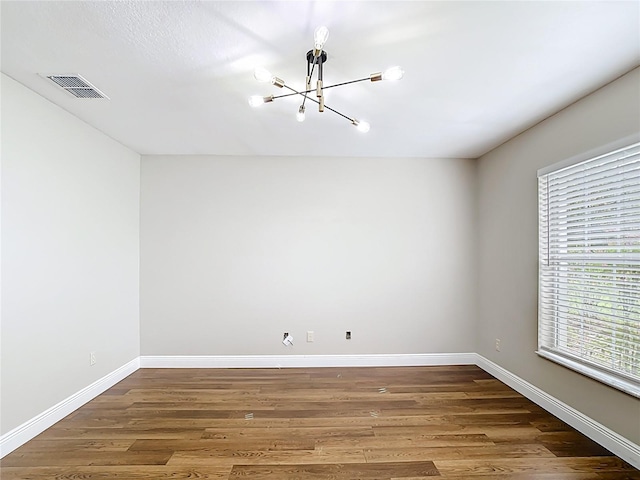 30 Lake Diamond Ave, Ocala, FL 34472 - spare room with a chandelier, wood finished floors, and baseboards