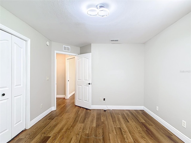 30 Lake Diamond Ave, Ocala, FL 34472 - unfurnished bedroom featuring wood finished floors, baseboards, and a closet