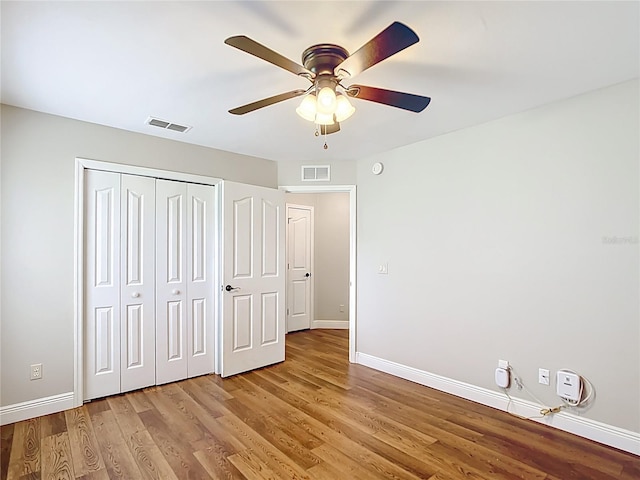 30 Lake Diamond Ave, Ocala, FL 34472 - unfurnished bedroom with baseboards, wood finished floors, a closet, and ceiling fan