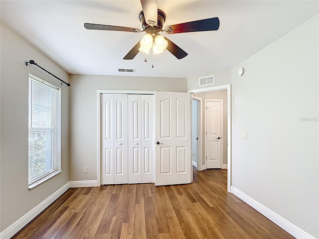 30 Lake Diamond Ave, Ocala, FL 34472 - unfurnished bedroom featuring baseboards, wood finished floors, and a closet