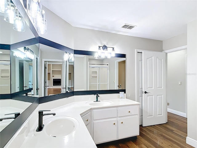 30 Lake Diamond Ave, Ocala, FL 34472 - bathroom with double vanity, wood finished floors, and baseboards