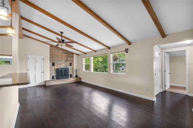 710 Carlton Ave, Lake Wales, FL 33853 - unfurnished living room with a large fireplace, ceiling fan, dark wood-type flooring, and baseboards