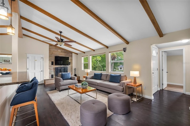 710 Carlton Ave, Lake Wales, FL 33853 - living room with ceiling fan, dark wood-type flooring, baseboards, and a stone fireplace
