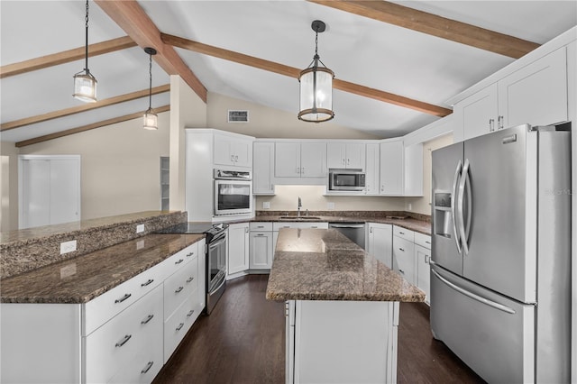 710 Carlton Ave, Lake Wales, FL 33853 - kitchen featuring stainless steel appliances, a sink, a peninsula, white cabinetry, and dark stone counters