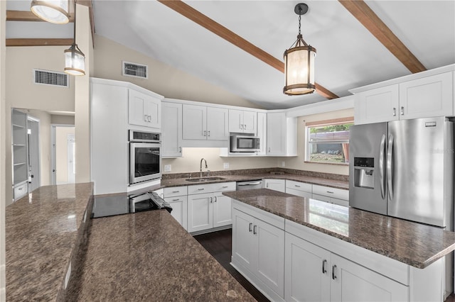 710 Carlton Ave, Lake Wales, FL 33853 - kitchen featuring a sink, stainless steel appliances, white cabinets, dark stone counters, and a kitchen island