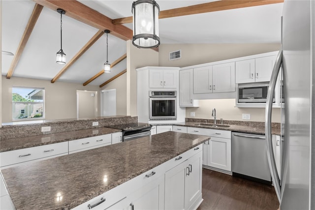710 Carlton Ave, Lake Wales, FL 33853 - kitchen with stainless steel appliances, a sink, white cabinetry, and dark stone counters